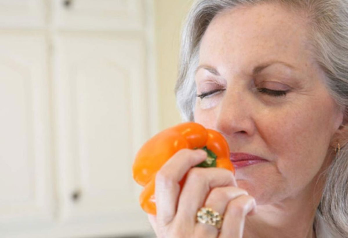 Señora oliendo pimiento