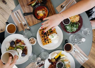 Mesa con alimentos y manos