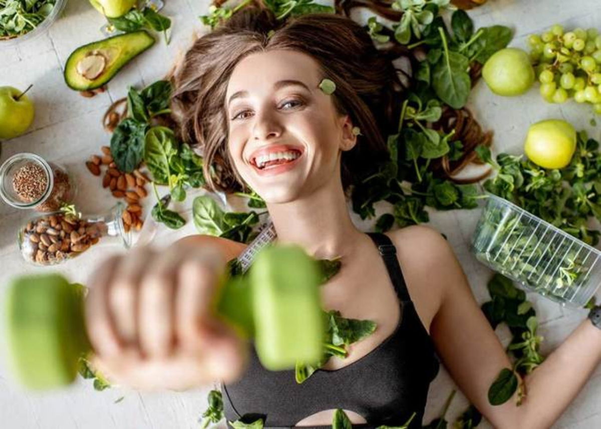 Mujer con mancuerna y alimentos