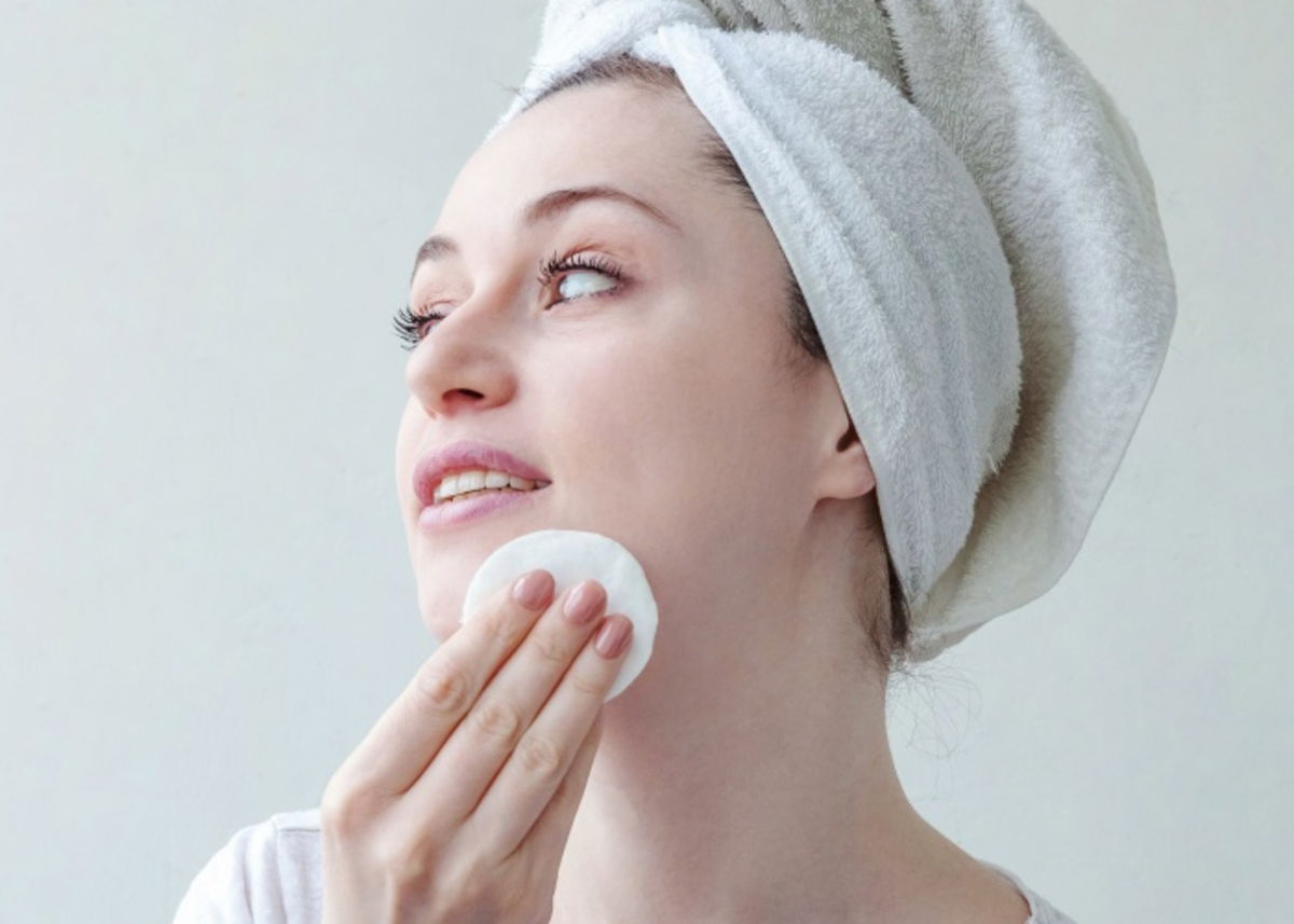 Mujer aplicando agua de arroz rostro